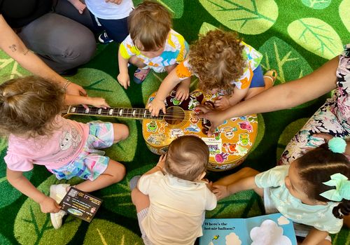 Children playing Music With Patrick's guitar