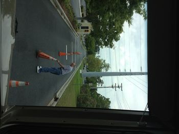 Ernie was moving the cones, Anna was driving and Debbie was taking pictures as evidence. We were moving the cones to keep from scratching up the coach on the trees, and we didn't get caught!
