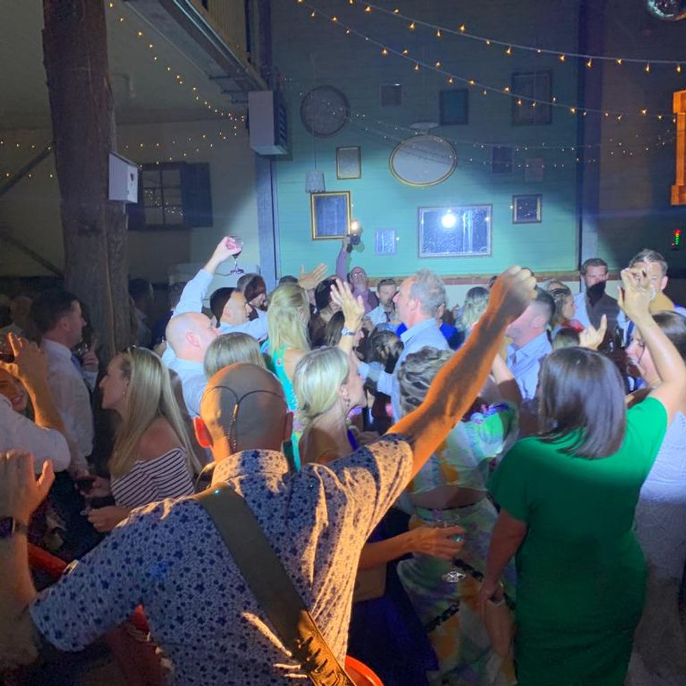 Devon and Cornwall wedding band New Heroes playing live to a full dancefloor with guests celebrating and dancing