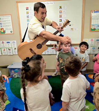Johnny Walylko engaging preschool students with live music, singing, and interactive learning activities.