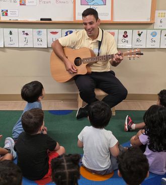 Preschool children enjoying Johnny Walylko's interactive music and movement program in the classroom.