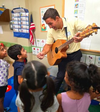 Johnny Walylko performing an interactive preschool music program with singing, movement, and hands-on fun.