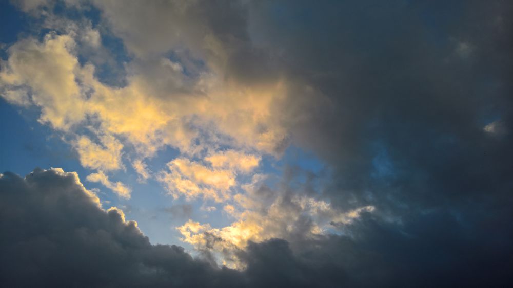 Clouds in sky with sun and shadow.