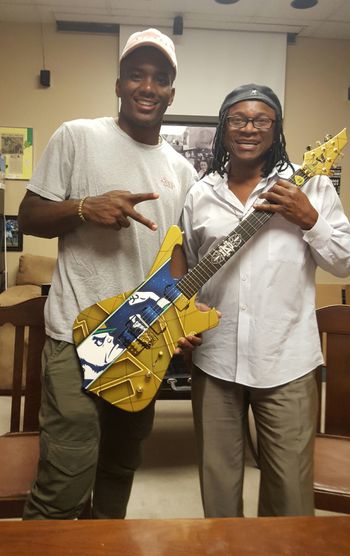 2017 ND QB Brandon Wimbush with Entertainer Darryl Buchanan holding a custom made ND guitar.

