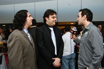 Chris Colby and Khaled Agha grant a television interview.
