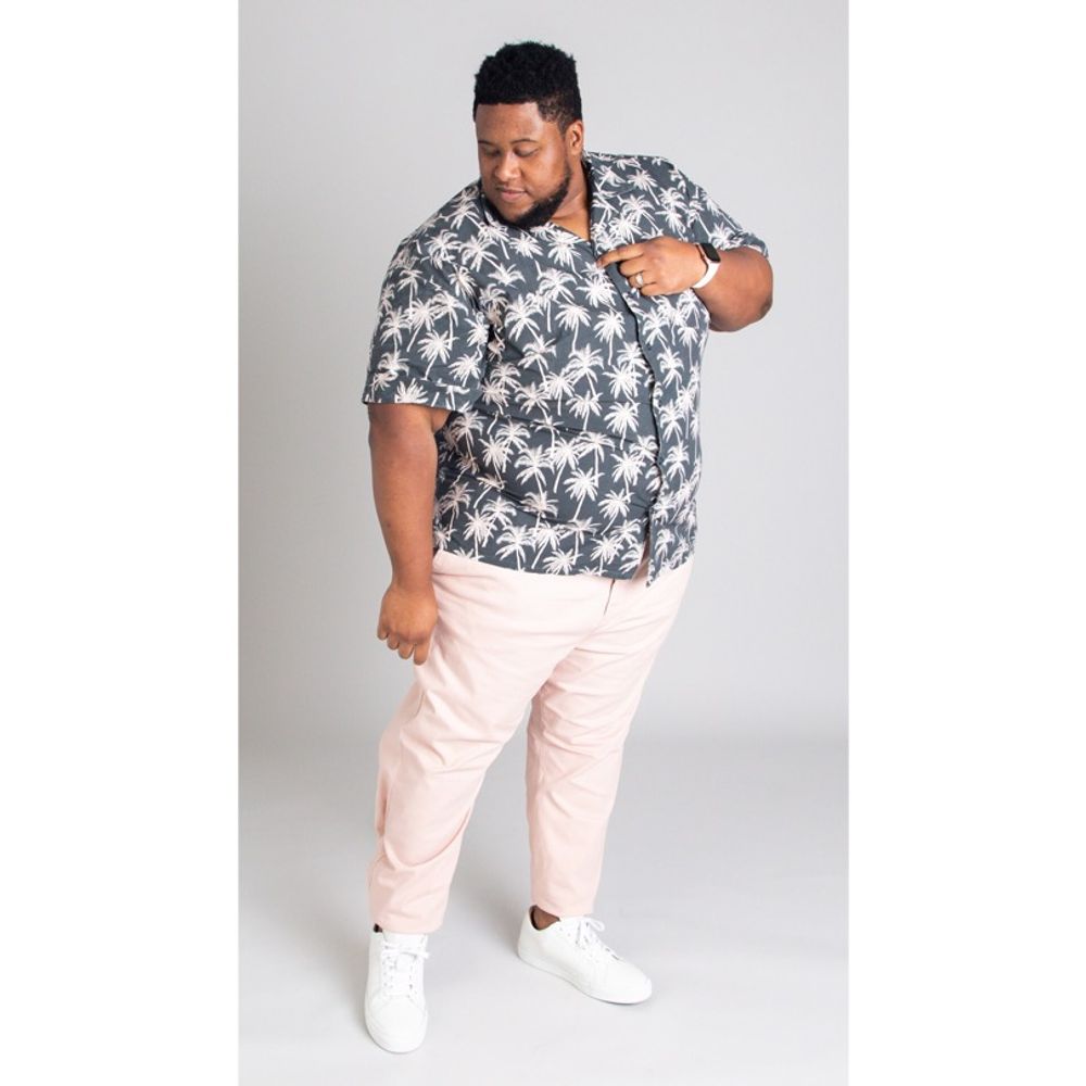 David TV Barnes full-length studio portrait in a floral shirt and pink pants