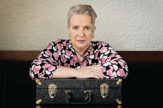 Colour photograph of Dorothy-Jane leaning on harmonica case. Photographer: Geoffrey Dunn. 2019 Canberra Australia