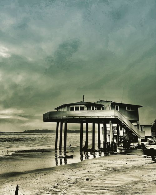 Dramatic picture of a wintery  sky and a house on stilts at the seaside, Stinson Beach, CA