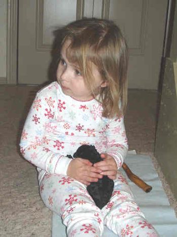 Alyssa gently holding 3 day old puppy
