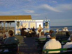 Audience takes in the concert, the sea...
