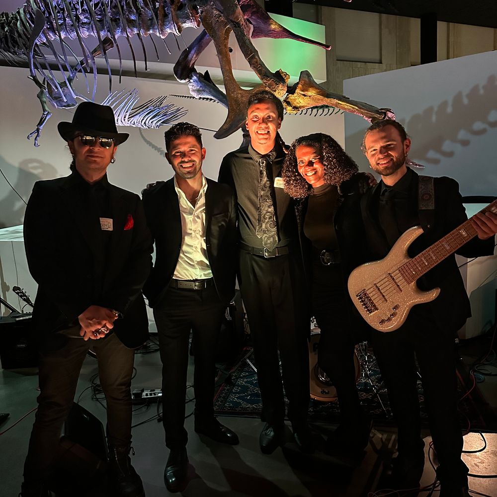 Darian Hernandez and backing band performing at a Houston business conference