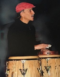 He's a poet, he's an artist, he's a singer, and he plays congas to die for!  If you come to a Crazy Feet Ballroom gig, he'll be there.  Yeah!.
