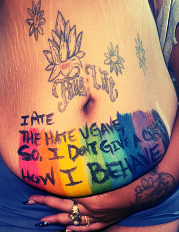 Words on Skin (UPCLOSE): THUG LIFE (The Hate You Give Little Infants Fucks Everybody) A message to end body shame, societal pressures, confronting body dysmorphia, and tribute to hate being spewed as a Black Femme Fat Girl.
