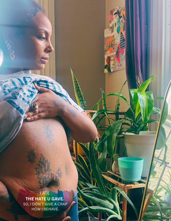 Words on Skin (bare excess skin): THUG LIFE (The Hate You Give Little Infants Fucks Everybody) A message to end body shame, societal pressures, confronting body dysmorphia, and tribute to hate being spewed as a Black Femme Fat Girl.
