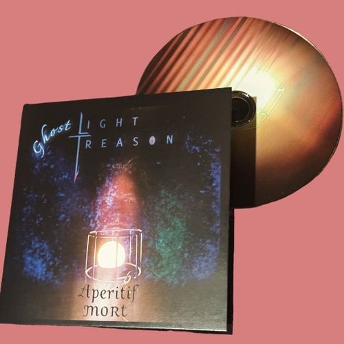 The album and CD art for for Light Treason's Aperitif Mort depicting a bearded man in his 30s peering through a vintage stage light.  
