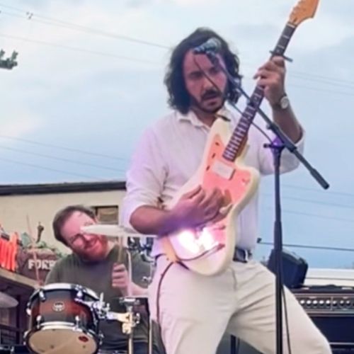 Andrew Savage, Austin folk rock musician, performs with Joe 'Hillcat' Hilling at the Workhorse Block Party on North Loop, playing a J Mascis Signature Squier Jazzmaster guitar.