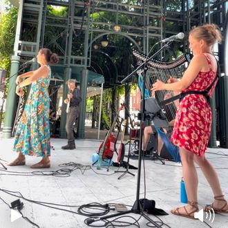 Shelley Otis performing with electric harp at an outdoor concert in Lowell, MA