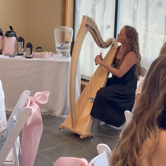 Shelley Otis playing harp for a bridal shower at New England Botanic Garden at Tower Hill