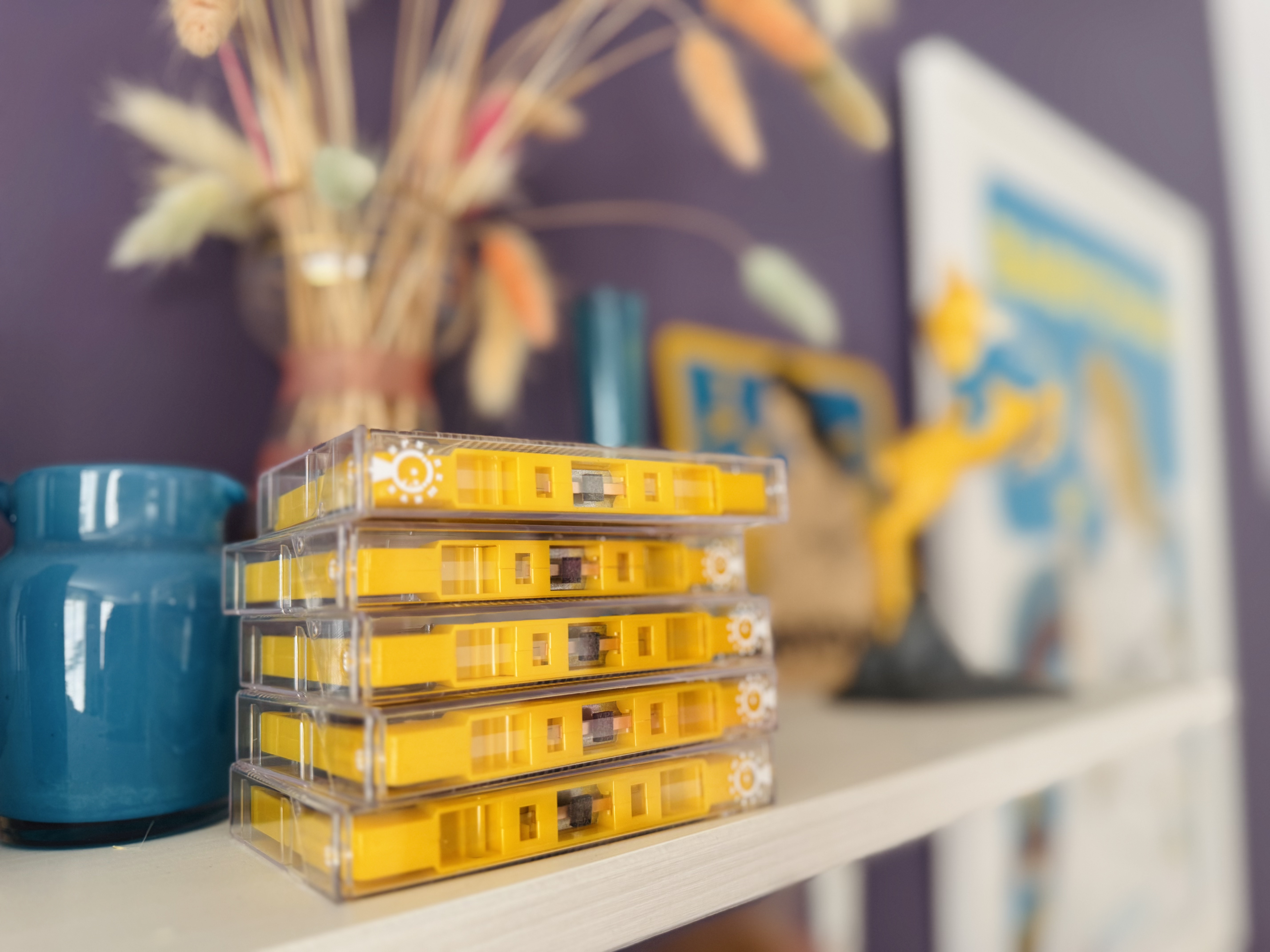 Stack of Ursinewave cassettes in front of ornaments.