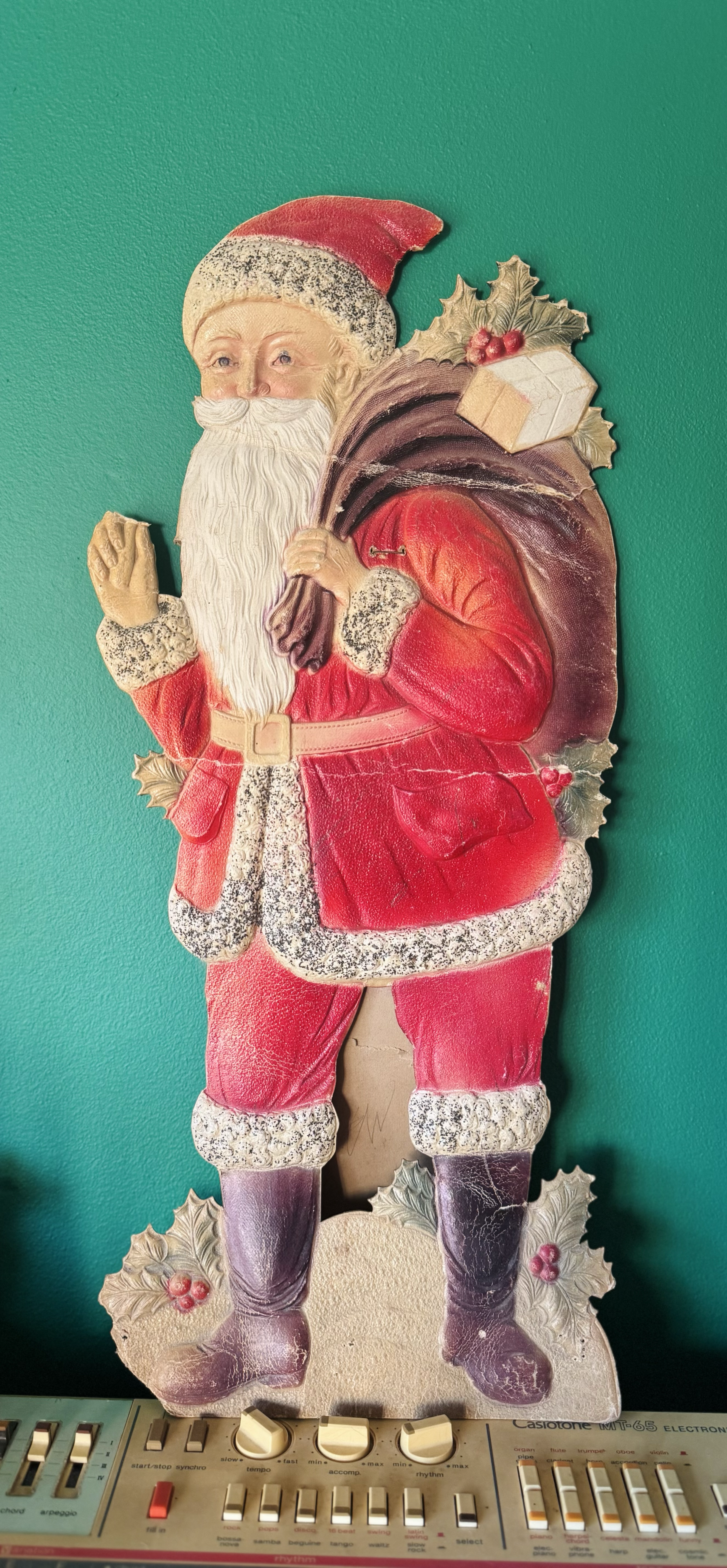 An awkward-looking Father Christmas decoration I bought a while ago, propped on a Casio MT-65 keyboard. The keyboard could do with a clean.