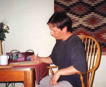 John working on a score for The Consort or perhaps writing some lyrics or a short story.
