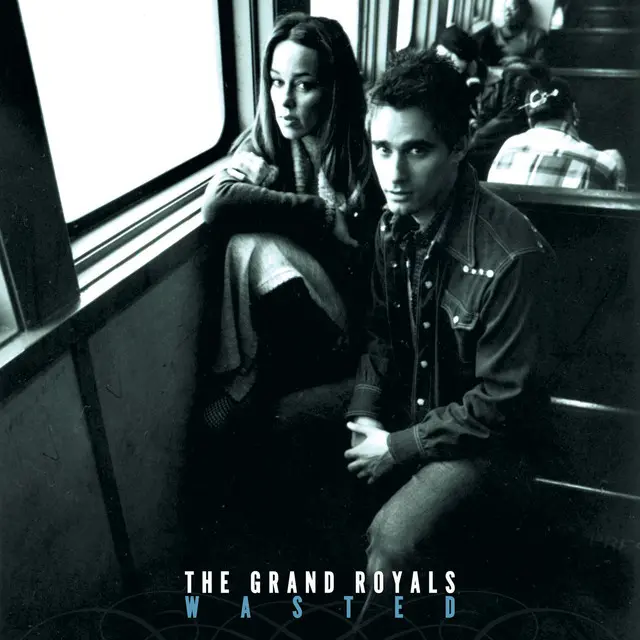 The album cover for 'Wasted' by The Grand Royals, featuring Jill Jones and Ian Ginsberg, with a gritty, indie-rock aesthetic.