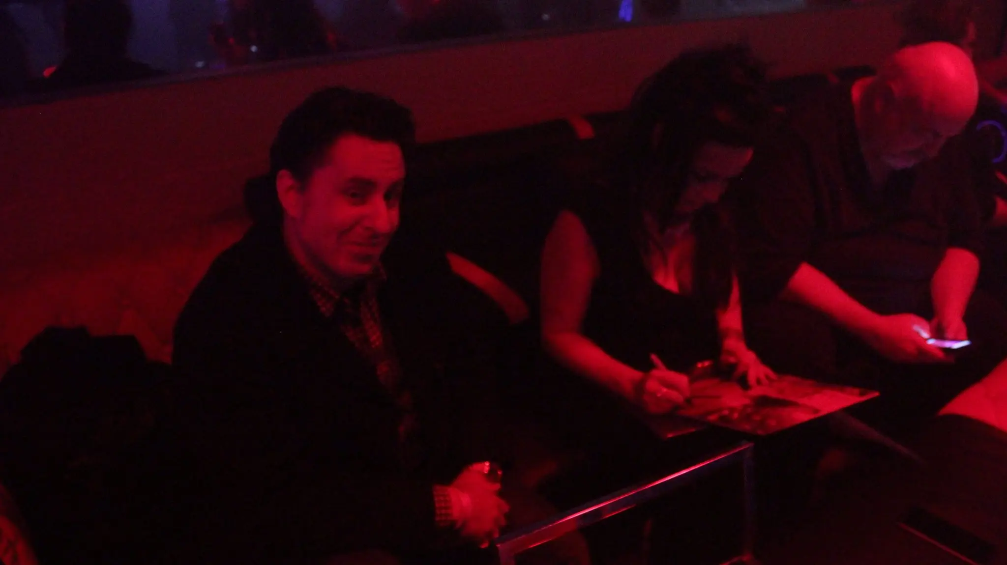 Jill Jones sitting between JJ Vicars and Clark Brooks in the VIP section of the Interbelt in Akron, signing records.