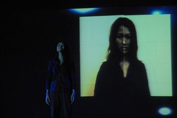 Amara is in front of a stunning image replicating the photos made of the Tuol Sleng victims
