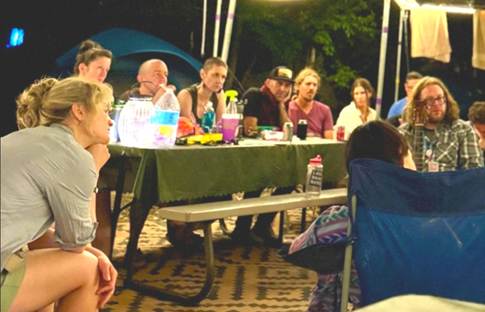 A group of people sitting at a table

AI-generated content may be incorrect.