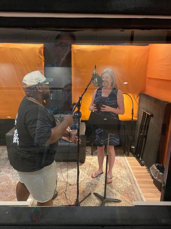 Charles adjusting the mic for Tara to record

