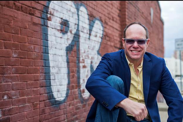 A person in a blue jacket and sunglasses

AI-generated content may be incorrect.