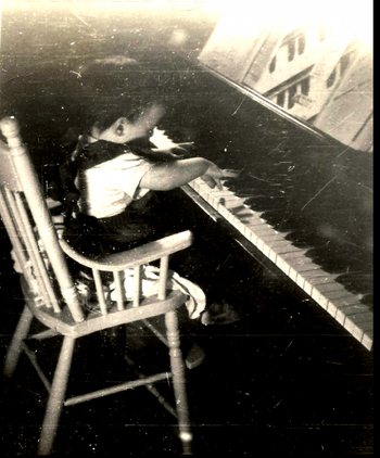 My fate was sealed from an early age. Is it any wonder my life has revolved around the sound of a piano?  It's an ADDICTION, I tell you! That's the sheet music for "Black & White Rag" on the rack--and I still own that very copy!
