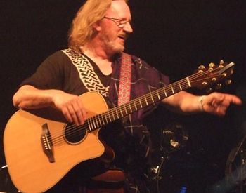 Bob singing with the audience at a concert theatre.
