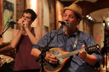Kyle Miller and ME at Stockade Imports Oh, I miss that acoustic blues series in Saratoga Springs. KM is blowing some harp for while I bang out Sleep John Estes on the National mandolin.
