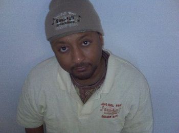 J.O.T. aka GRANDE GATO wearing 2010 beige polo style shirt with SOUL-FULL logo.  Also wearing toboggan.
