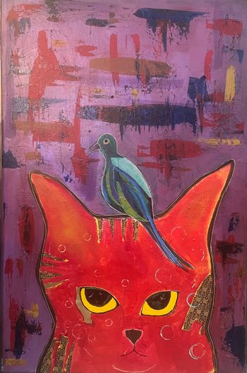 Blue Bird Perched on Red Cat's Head
