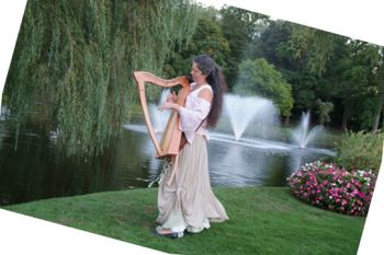 my "strolling" harp and one example of Renaissance garb.  These "strolling harp" photos were  taken by Jeffrey Studio Photography, who impressed me with their artistic eye and their generosity sharing
