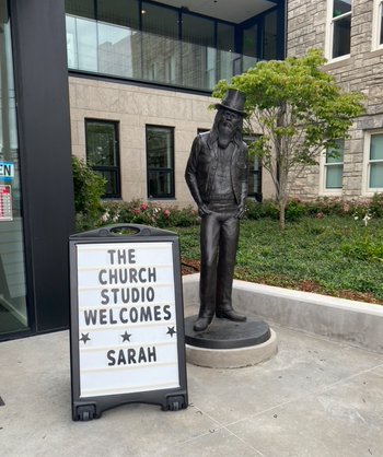 Statue of Leon Russell next to sign welcoming Sarah to the studio
