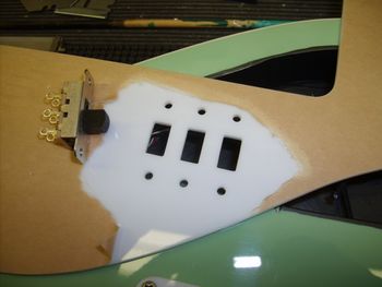 The guard has been cut to accept three slider pickup selector switches....
