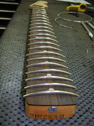 The neck is also refretted at this time
