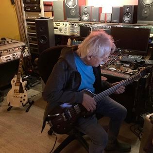 Phil laying on bass guitar during Critical Misunderstandings On The Precipice sessions.
