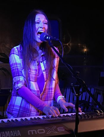 Kimberlee M Leber Singing with All Her Heart in Concert
