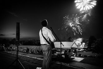 Singer and acoustic guitarist performing at 4th of July fireworks show at a country club in Lincoln, RI. 