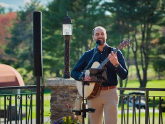 Live acoustic guitarist performing for a corporate golf tournament and cocktail hour on an outdoor country club patio in Andover, MA.