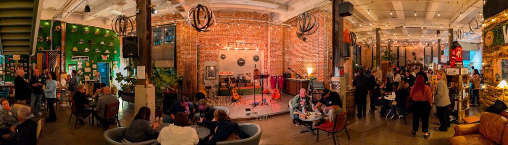 Acoustic guitarist and singer stage and atmosphere of after-party corporate event for a company annual sales meeting after-party.