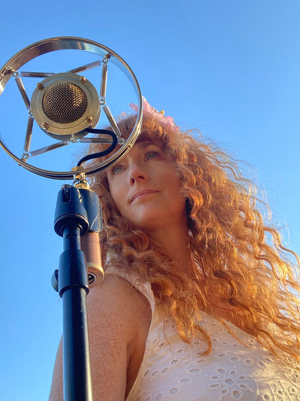 Caption: Heather Richards during an outdoor recording session beneath the summer sky.