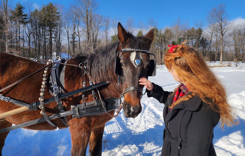 Heather Richards with horse in a snowy winter setting, featured on the Scarlet Berries song page.