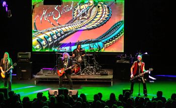Y&T on stage with the Mean Streak backdrop.
