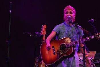 Hannah from Sound of the Sirens singing to the crowd at Beautiful days Festival 26 | The Source Studio Exeter
