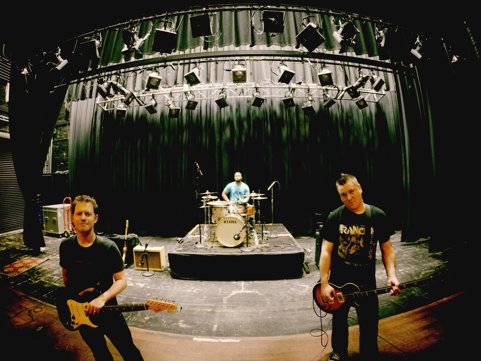 7 Sharp 9 three-piece on stage: two guitars and drums